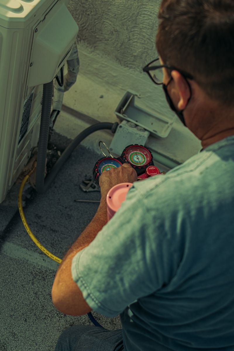 Electrical and air conditioning technician at work