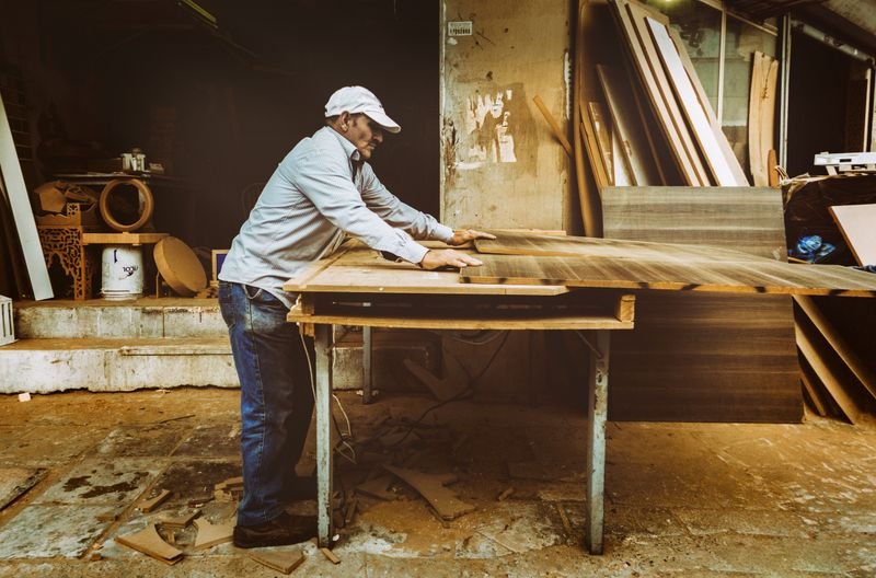 Carpenter working with timber in a workshop