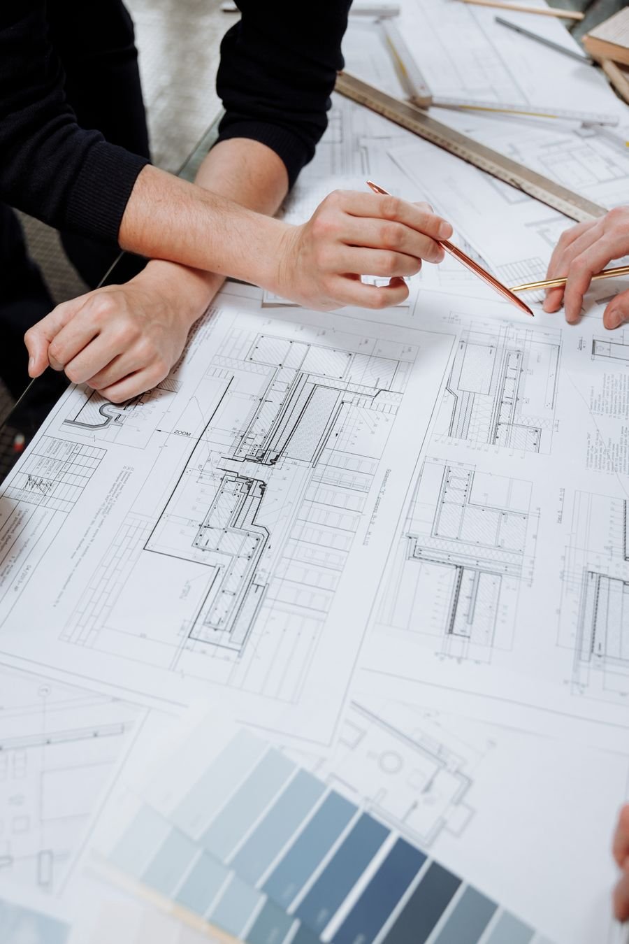 Architectural plans and material samples being reviewed