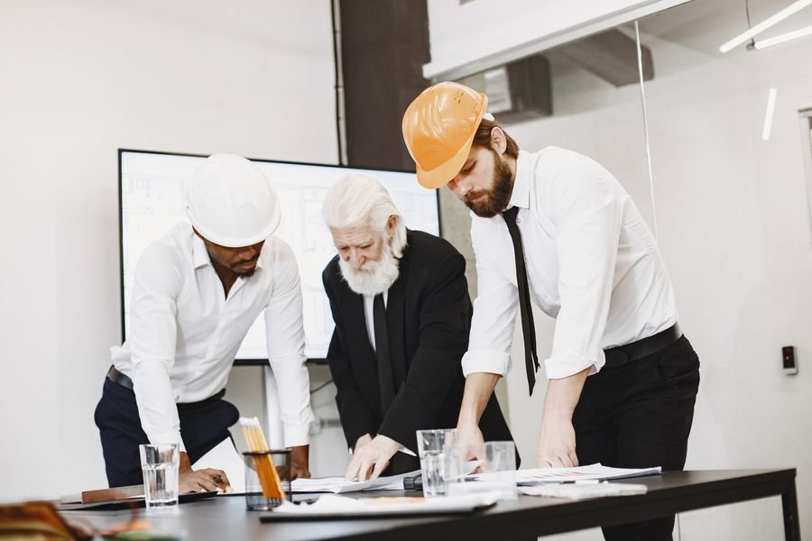 Engineers reviewing architectural plans together